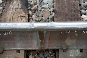 Fototapeta na wymiar Emporia, Kansas 5-16-2015 Examples of railroad track repairs in Emporia, Kansas at the main crossing on Commercial street. Showing where the tracks have been welded and the dates and by whom. 