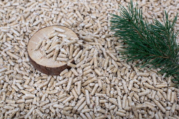 Coniferous pellets - pile of wooden pellets, slice and branch