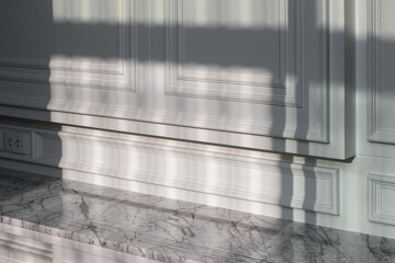 close up of white wood wall with shadow in house