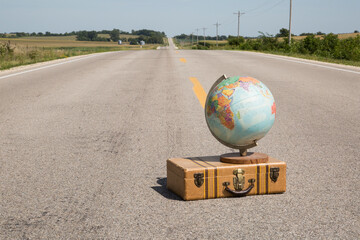 Globe on a Suitcase on a Rural Road
