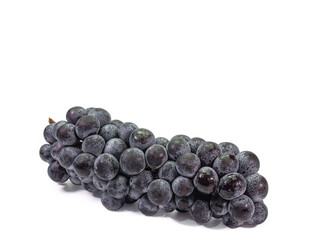 The close up of ripe organic black seedless grape bunch, healthy juicy berry fruits isolated on white background.