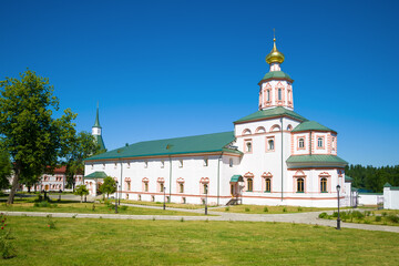 Fototapeta na wymiar Church of the Epiphany with a refectory (1655-57) in the Valdaisky Ivesky Svyatoozersky monastery on a sunny July day. Novgorod oblast, Russia