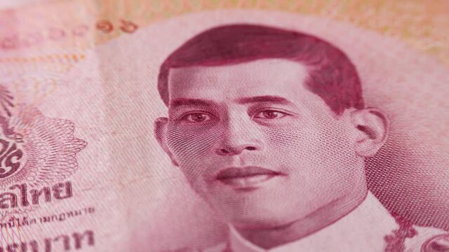 Face King of Thailand Rama X on official currency banknote. Paper Baht or THB bill