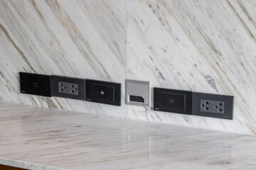 Design the plug to fit perfectly on the marble wall, modern black electrical plug