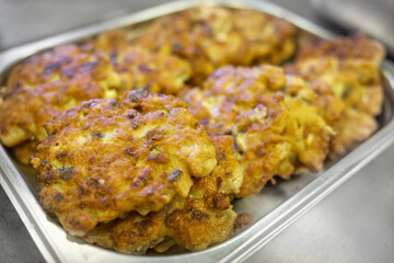 Fried chicken chops in batter are laid out for serving. Close-up of delicious and appetizing food. Background