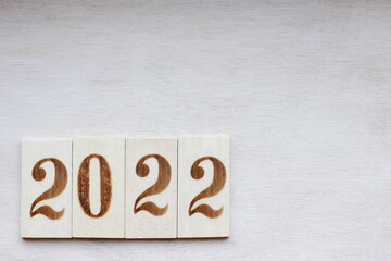 Fototapeta na wymiar 2022-the New Year's number is laid out in wooden numbers on a wooden surface