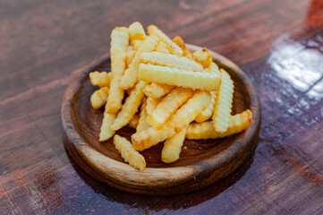french fries with parmesan cheese on wooden board