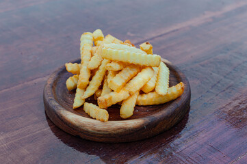 french fries with parmesan cheese on wooden board