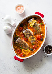 Fish steaks, olives and cherry tomatoes stewed  in tomato sauce