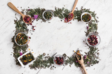 Frame made of dry green tea leaves on light background