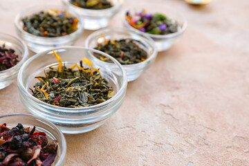 Composition with different green tea leaves in bowls on light background