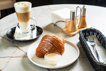 croissant and cappuccino in the cafe