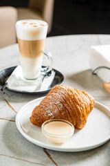 croissant and cappuccino in the cafe