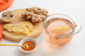 Cup of healthy tea with lemon, ginger and honey on table
