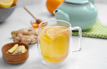 Cup of aromatic tea with lemon, ginger and honey on table