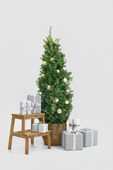 Beautiful decorated Christmas tree with gift boxes on white background