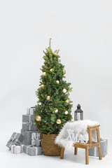 Beautiful decorated Christmas tree with gift boxes on white background