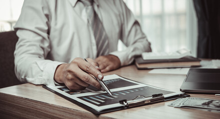 Male investment businessman has analyzed the market of the stock graph and evaluated the financial risks with the Business Intelligence Finance dashboard in a laptop, Stock market concept.