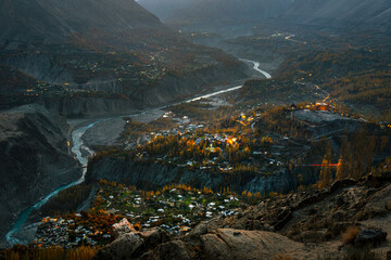 mountain valley with zigzag river and autumn trees in evening light of golden hour 