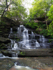 Tall waterfall cascade in the rainforest.