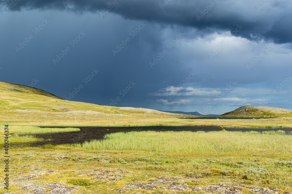 Sticker Mountain lake with dark storm clouds in the sky