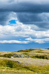 Dark clouds over wild moorland landscape