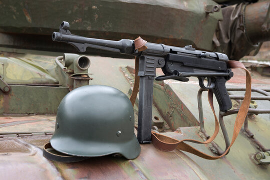 German  submachine gun and helmet on the armor of the tank