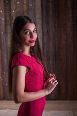 Fototapeta premium woman model in elegant red dress. Beautiful girl studio shot on wooden background.