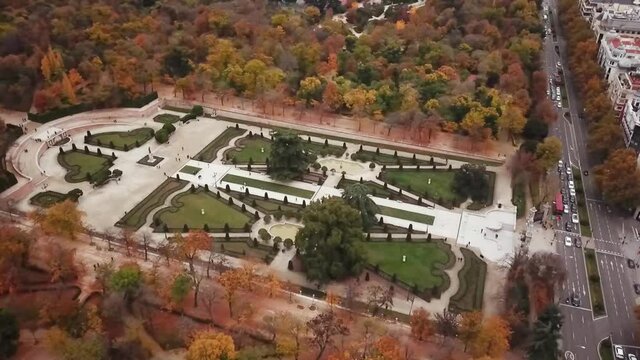 Spain Madrid capital drone shot aerial look view from above city Parque de El Retiro Parterre Garden fly over pan left park autumn