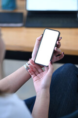 Mockup image woman hand holding mobile phone with white blank screen for text.