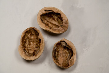 Chopped nuts on a neutral gray background, nutshells