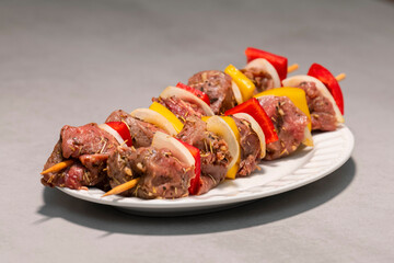 Seasoned beef and vegetables skewers ready to be cooked
