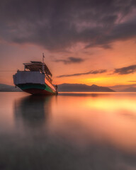 The color of the sunset is so beautiful that the boat is docked