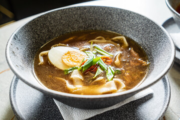 asian soup with noodles and egg