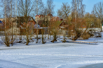 Rural landscape with wooden houses in winter