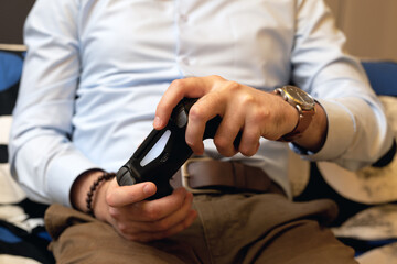 Gaming adult man holding simulator keypad joystic. Video game console controller in gamer hands, close up. Front view