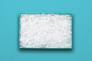 Top view, white paper filler in blue carton box