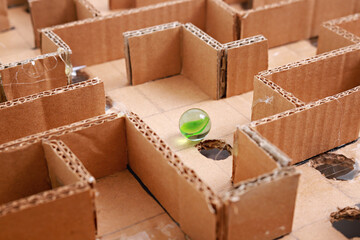 Close up of a handmade cardboard maze game puzzle.