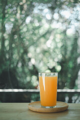 Fresh orange juice in glass. Outdoors table