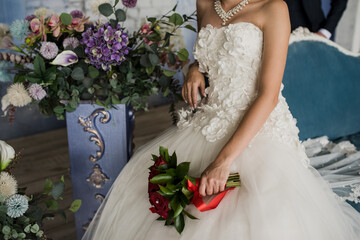 the bride holds a beautiful bouquet of flowers