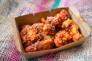 Deep fried chicken wing with hot and spicy sauce in Korean style or asian food concept.
