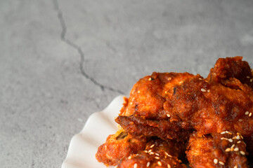 Deep fried chicken wing with hot and spicy sauce in Korean style or asian food concept.