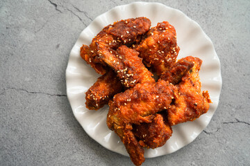 Deep fried chicken wing with hot and spicy sauce in Korean style or asian food concept.