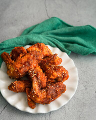 Deep fried chicken wing with hot and spicy sauce in Korean style or asian food concept.