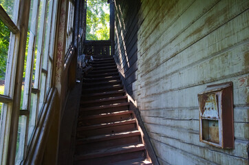 Stairways to the upstairs of burned house. Old abandoned house made with wood. Old mailbox hanging on the wall. Vorokhta, Ukraine.