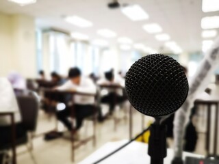 Microphone in class while teaching There is a blurry image for students in the background.