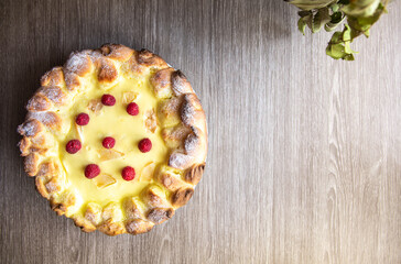 Desserts flat lay for bakery or restaurants. Top view on fresh and crispy baked at home cheese pie on gray wooden background. Baking pastries on holidays. Close up on golden color cheesecake.