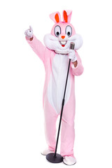 Funny crazy singer Easter bunny or rabbit sings in retro vintage microphone, celebrates easter, dances isolated on white background. Happy musician, rabbit or hare having fun