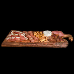 Charcuterie on a wood board with black backgound