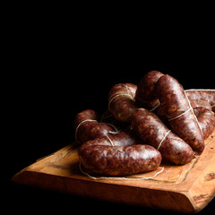 Charcuterie on a wood board with black backgound